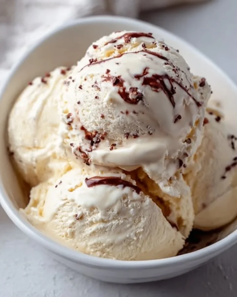 Delicious bowl of Bailey's Ice Cream topped with chocolate sauce and sprinkles.