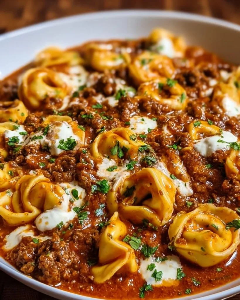 Delicious cheesy beef enchilada tortellini served with toppings.