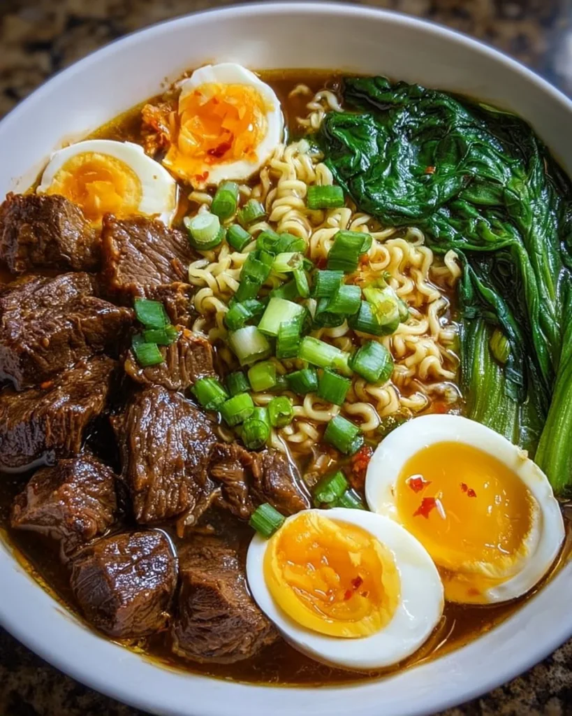 Delicious Slow Cooker Beef Ramen Noodles topped with garnishes in a bowl.
