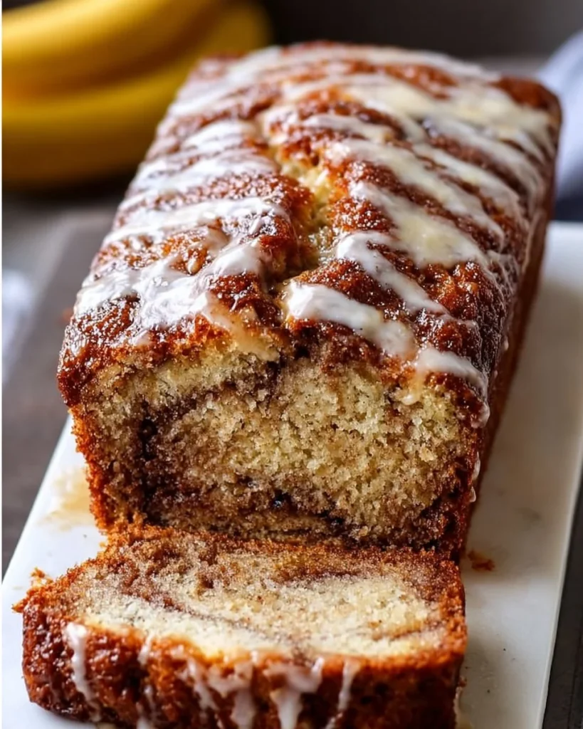 Slices of cinnamon swirl banana bread on a wooden board