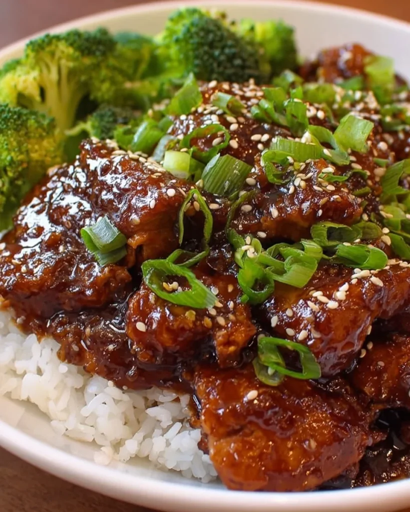 Slow Cooker Teriyaki Chicken served on a plate with steamed rice and vegetables