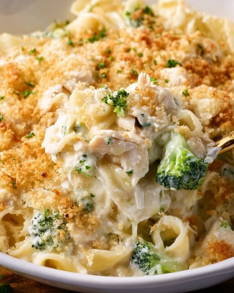 Baked Chicken Alfredo dish topped with melted cheese and parsley