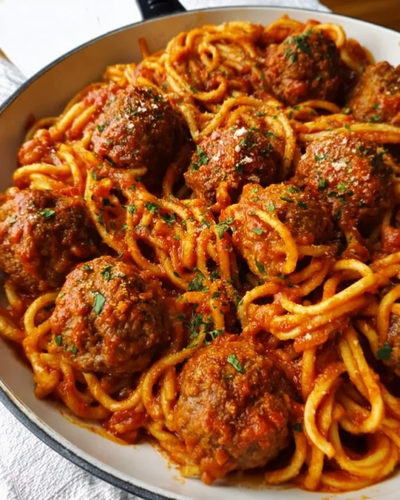 Delicious plate of spaghetti and meatballs garnished with parsley