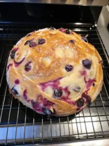 Blueberry Lemon Cream Cheese Sourdough Bread served with a slice cut out