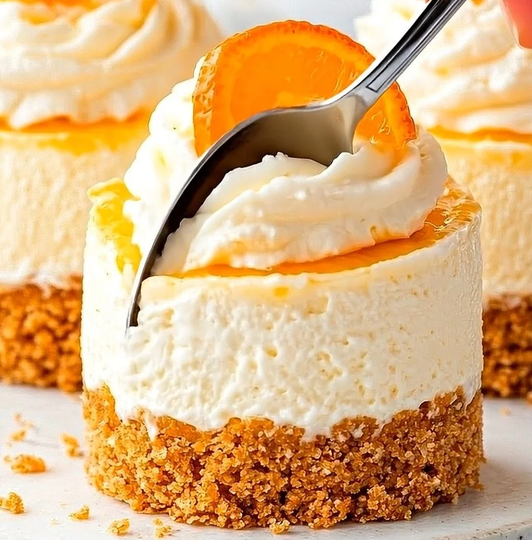 Mini orange cream cheesecakes topped with fresh orange zest