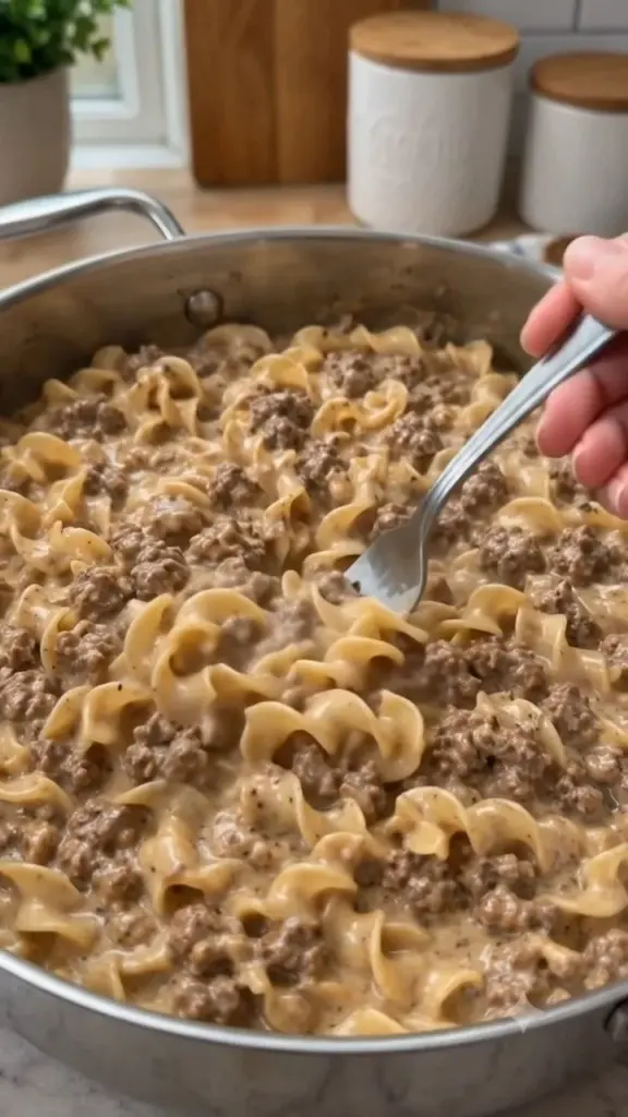 A delicious plate of creamy beef and egg noodles topped with herbs