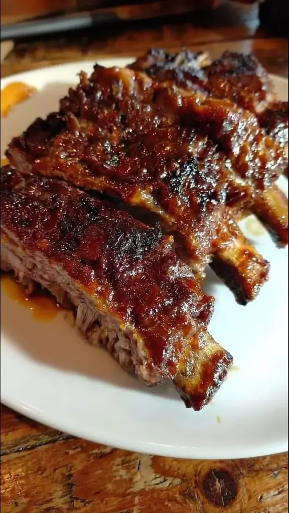 Delicious crockpot barbecue ribs served on a plate with sauce