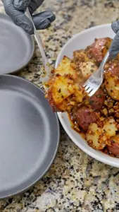 Garlic butter roasted red potatoes on a white plate with herbs