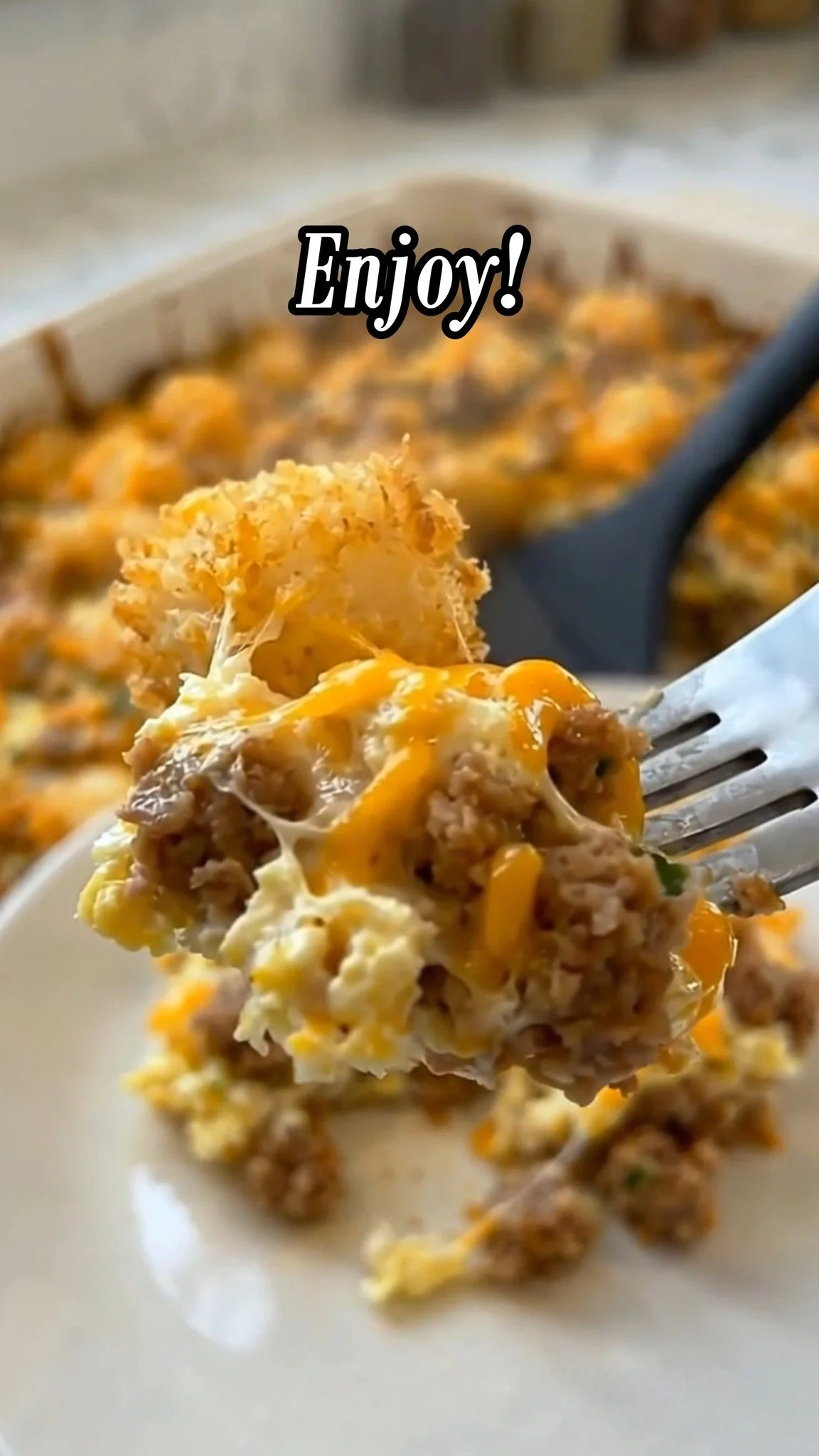 Sausage cream cheese tater tot breakfast casserole topped with herbs