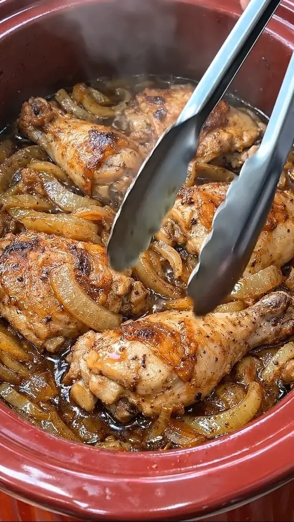 Slow Cooker Caramelized Onion Chicken served on a plate with herbs