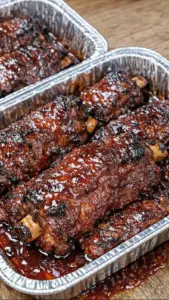 Sticky BBQ beef short ribs served on a platter with a savory glaze.