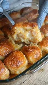 Freshly baked sticky honey pull-apart rolls on a wooden table