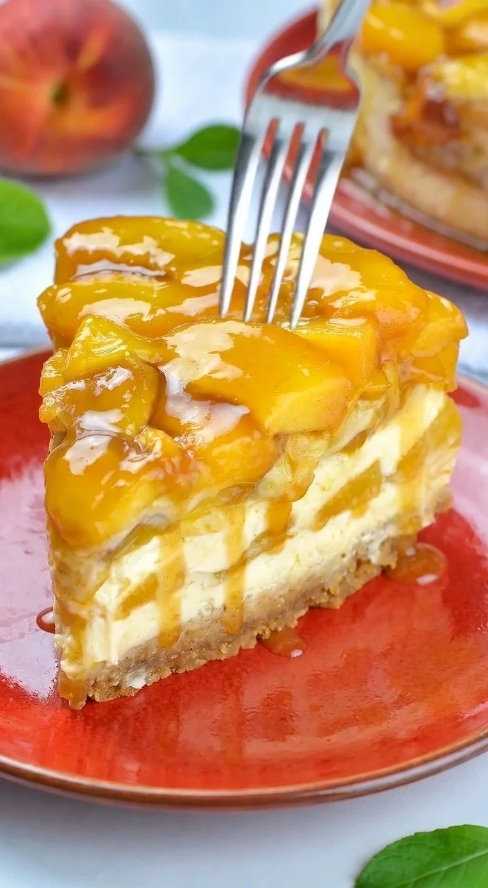 Delicious sugar-free peach cobbler cheesecake topped with fresh peaches