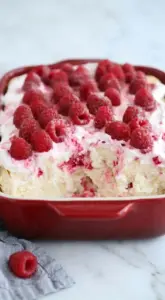 Sugar-free raspberry cream angel food cake topped with fresh raspberries
